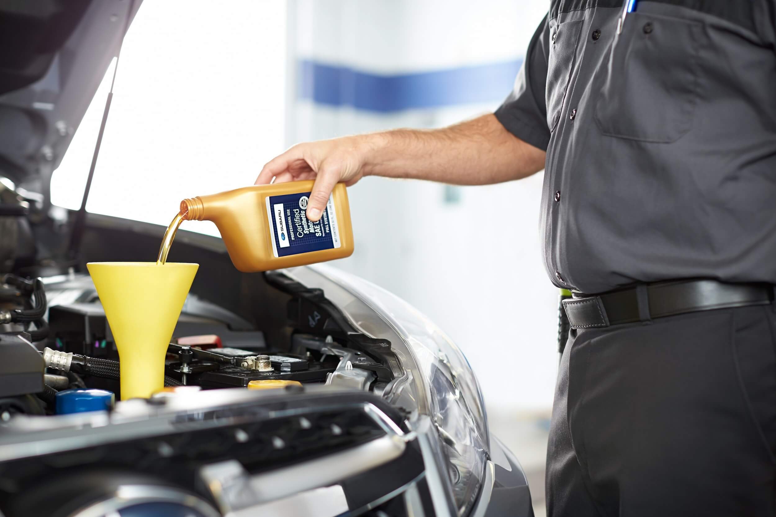 A mechanic servicing a Subaru