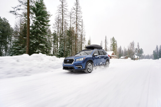 A blue Subaru Ascent in the snow