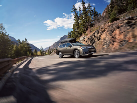 A black Subaru Outback in the mountains
