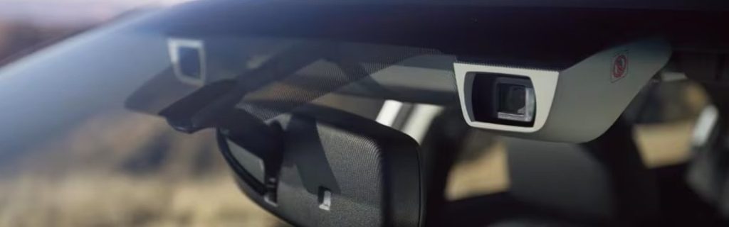 Close-up of a Subaru EyeSight system camera mounted near the rearview mirror.