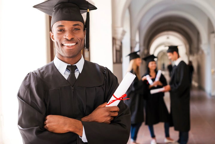 college graduate holding his diploma | Fitzgerald Subaru of Gaithersburg in Gaithersburg MD
